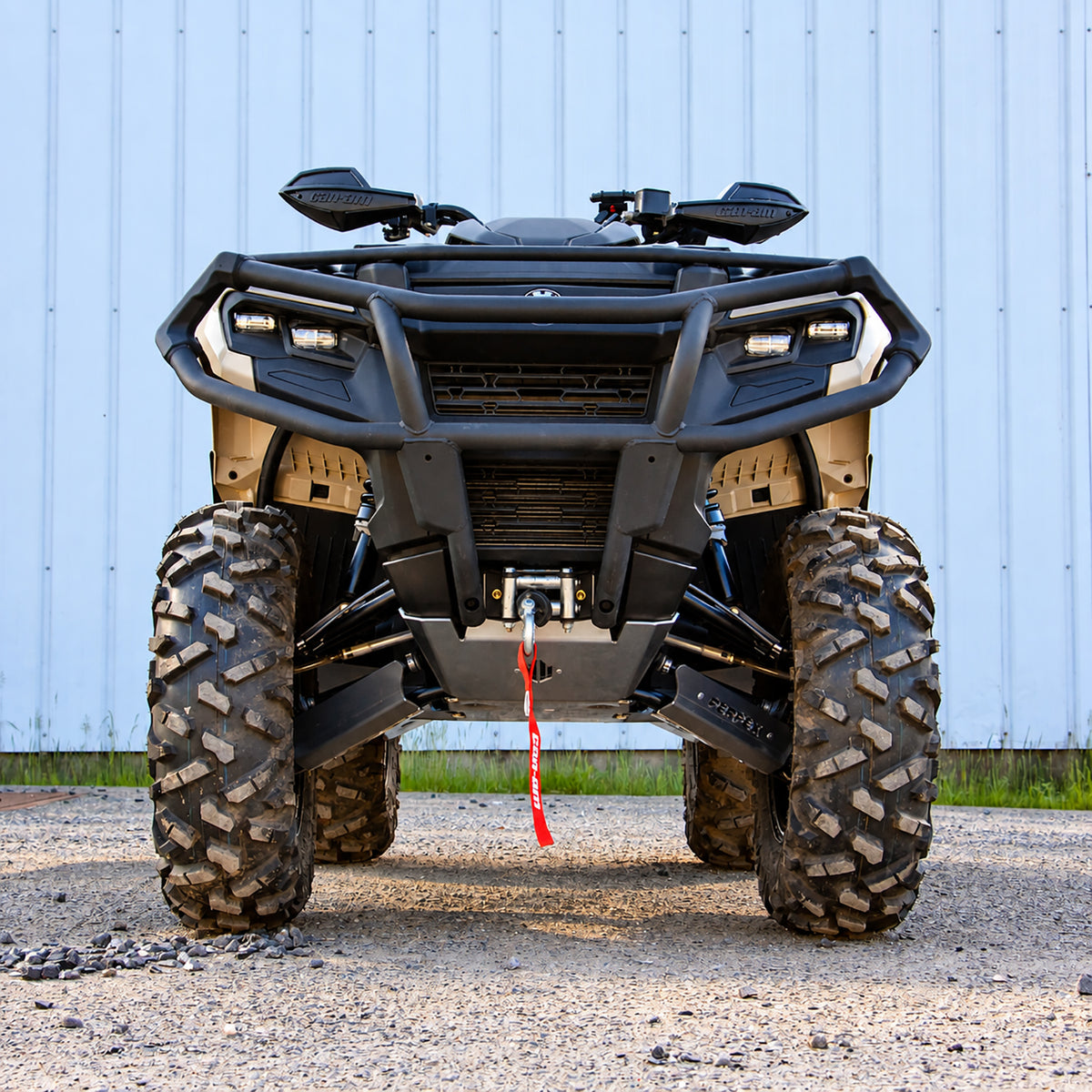 Front view of a Can-Am Outlander 700 PRO with PERFEX 1-inch lift kit installed, showing the lifted stance and front suspension.