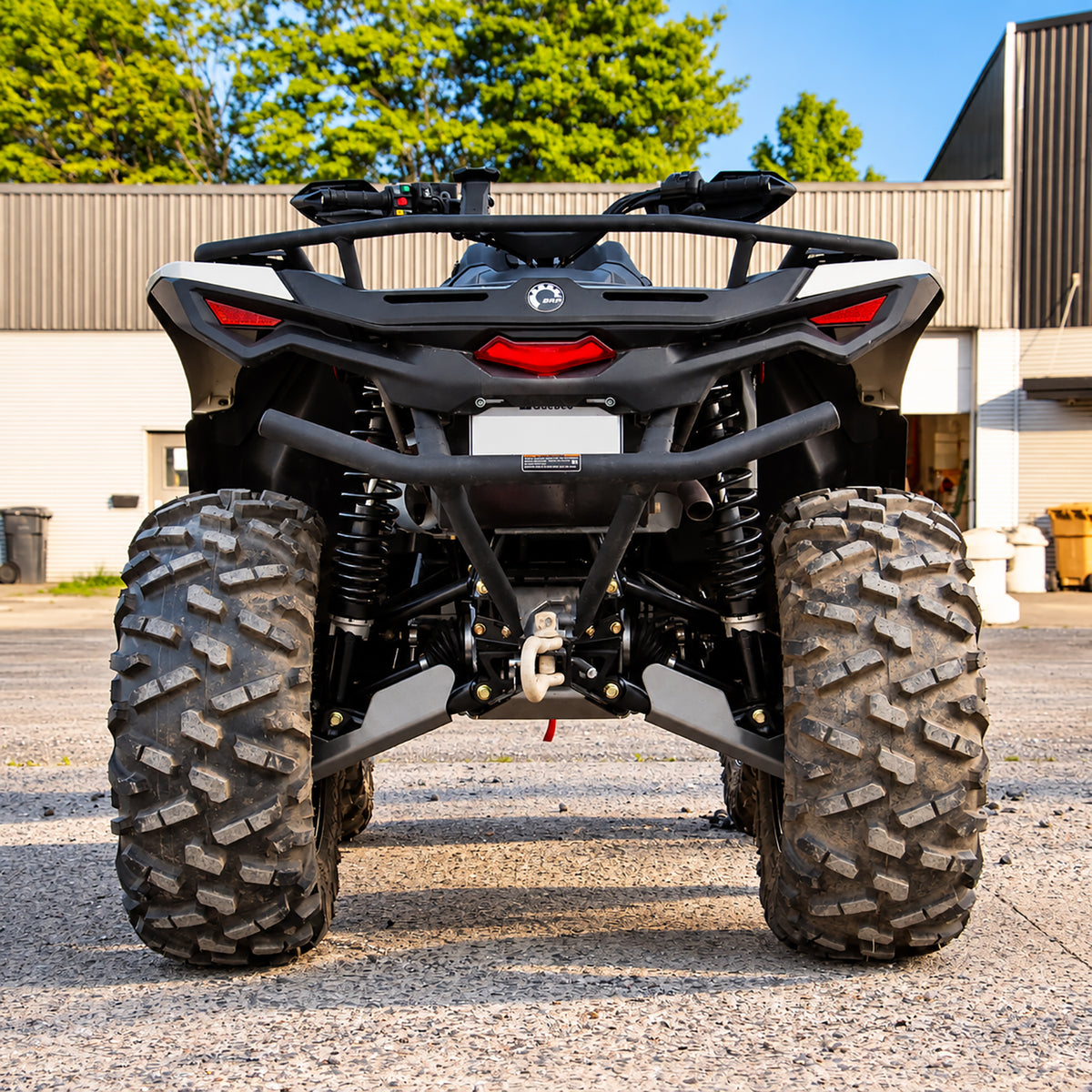 Rear view of a Can-Am Outlander 700 PRO equipped with a PERFEX 1-inch lift kit, showing the rear suspension and ground clearance.