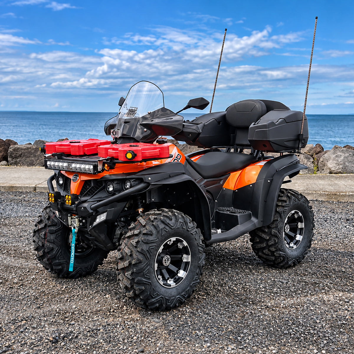 Orange CFMOTO CForce 500 HO ATV equipped with a PERFEX 1.5-inch lift kit, shown from a front three-quarter angle by the waterfront.
