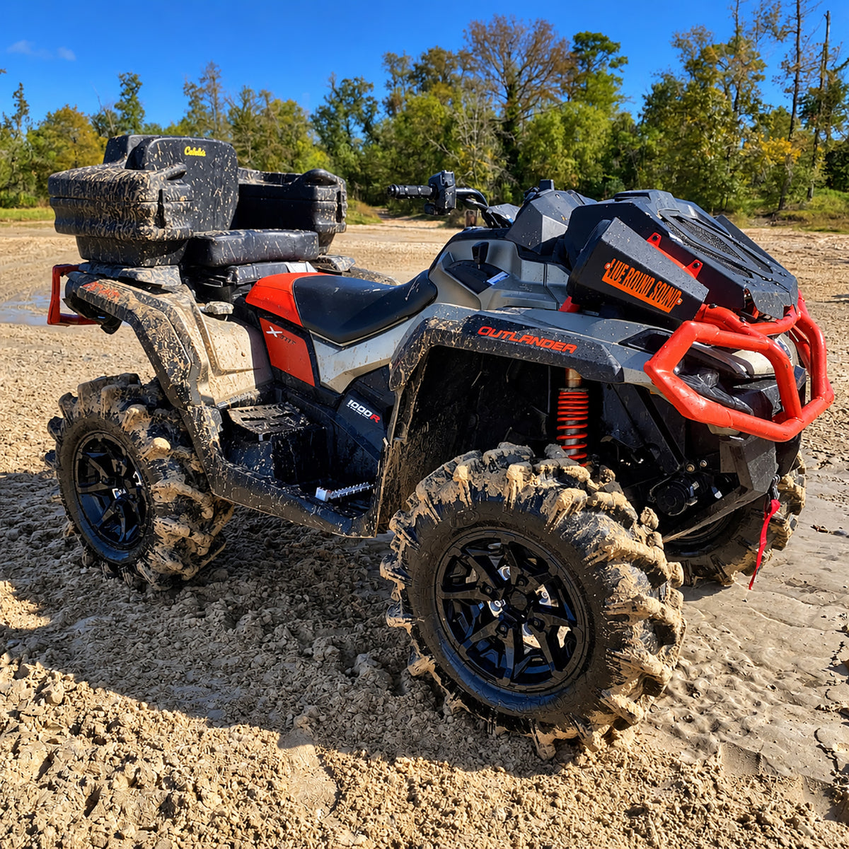 Mud-covered Can-Am Outlander X MR 1000R equipped with a PERFEX 2-inch lift kit and aggressive mud tires.