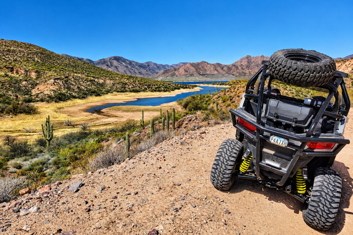 Lifted Polaris RZR Trail 900 rear view showing increased ground clearance on rocky trail.