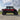 "CFMoto UForce U10 XL Pro Highland in red with PERFEX 2.5in UTV lift kit and 32-inch System3 RC500 tires — aggressive off-road stance with visible cube lights