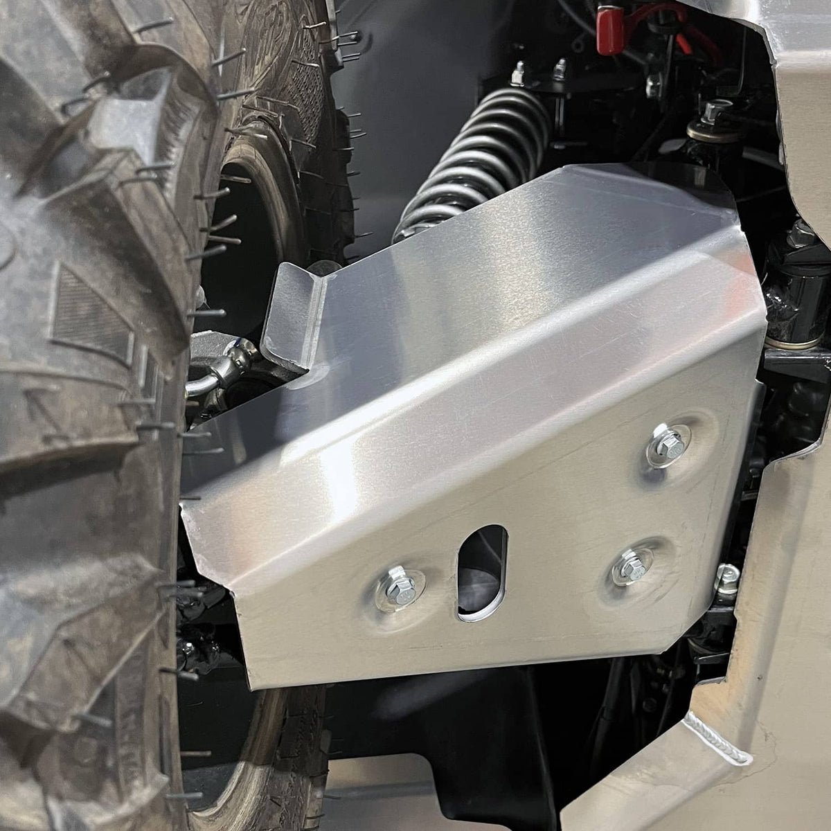 Close-up view of PERFEX Industries 3/16" heavy-duty aluminum 5052 front right a-arm guard, showcasing enhanced protection for 2023 Kawasaki Brute Force 750 ATVs during off-road use.