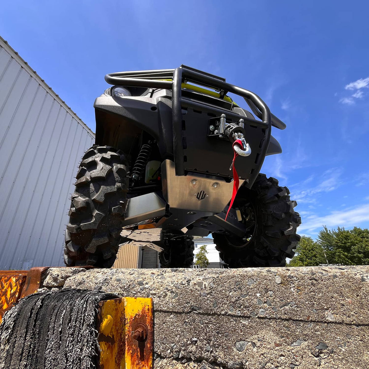 Front view of PERFEX Industries durable 3/16" aluminum skid plate with a 2-inch lift kit on a 2023 Kawasaki Brute Force 750, enhancing ATV off-road performance.