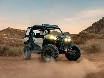 Can-Am Commander 1000 UTV, equipped with Perfex LED light, completing its desert ride against the backdrop of a sunset.
