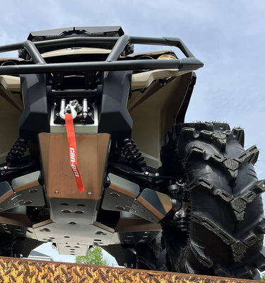Underside view of a four-wheeler featuring the full protection manufactured by Perfex. The high-quality and durable nature of the parts is evident.