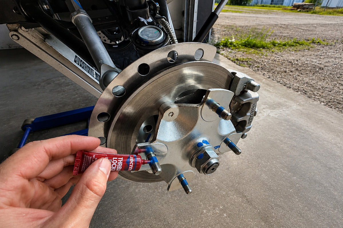 Applying blue thread locker to the factory wheel studs before installing the ATV or UTV wheel spacer.