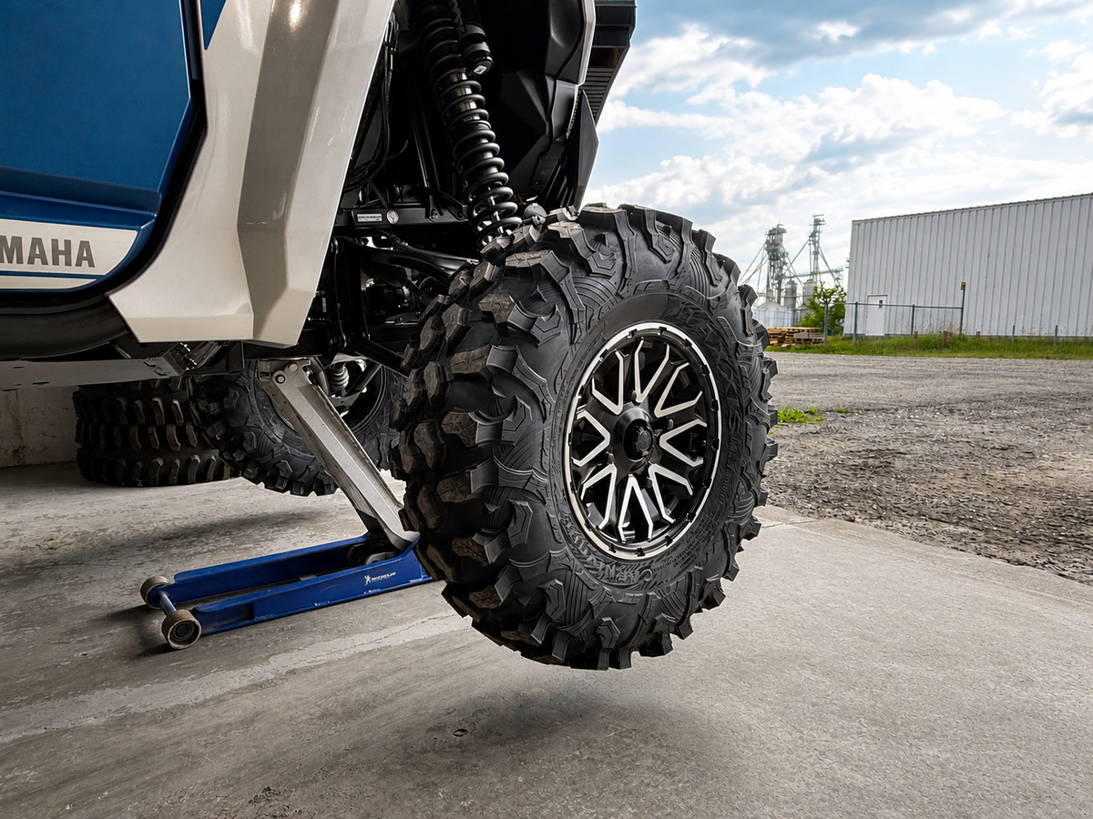 Reinstalling an ATV or UTV wheel onto the wheel spacer studs and hand-tightening the wheel lug nuts before final torque.