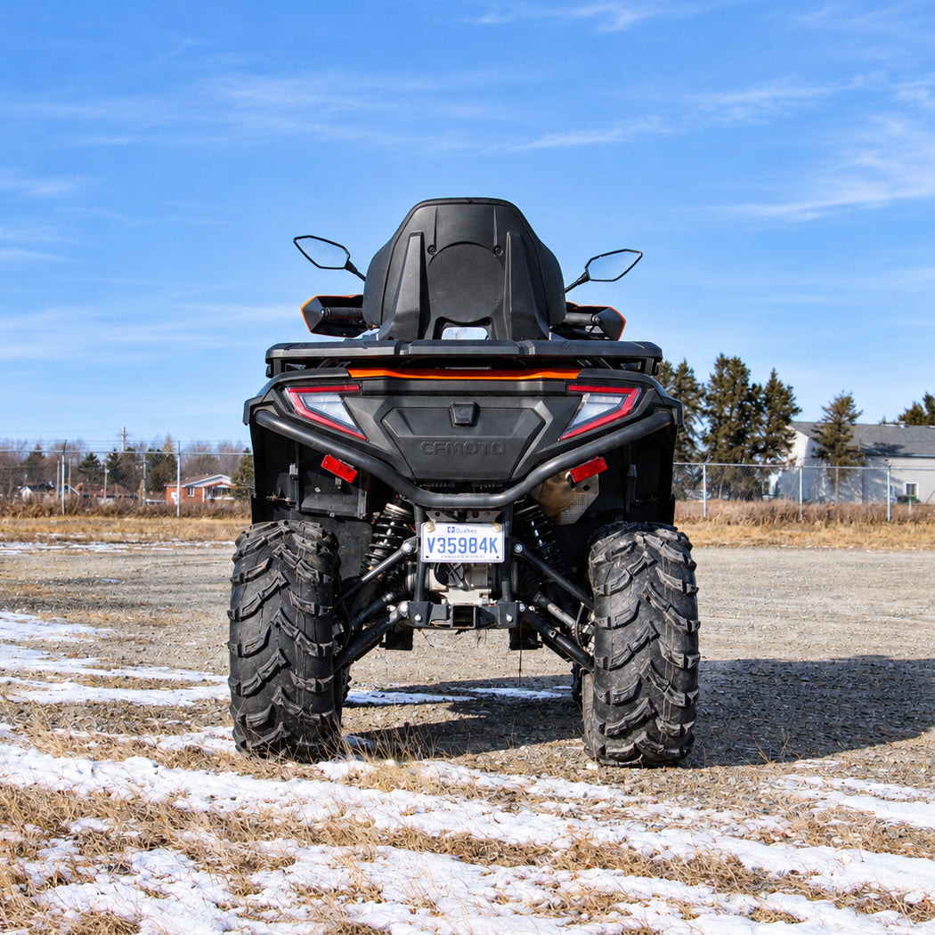 Rear view of a lifted CFMOTO CForce 600 Touring highlighting its suspension and ground clearance.
