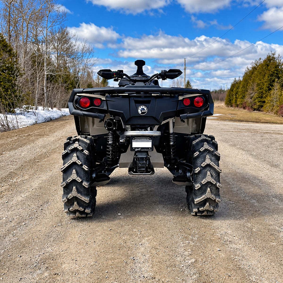 Rear view of a Can-Am Outlander X MR 850 showing the lifted suspension and wider off-road stance.