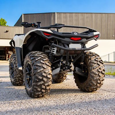 Rear three-quarter view of a Can-Am Outlander 700 PRO with PERFEX 1-inch lift kit, showing the rear suspension and lifted stance.