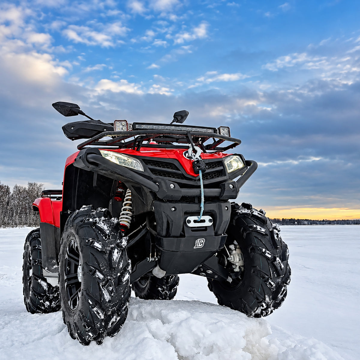Low-angle front view of a red CFMOTO CForce 500S ATV with a PERFEX 1.5-inch lift kit and aggressive 28" mud tires in the snow.