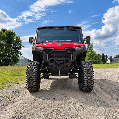 Front angle shot of lifted red CFMOTO UForce U10 XL Pro Highland with 2.5-inch PERFEX lift kit and System3 RC500 tires — off-road ready with PERFEX mounting brackets installed.