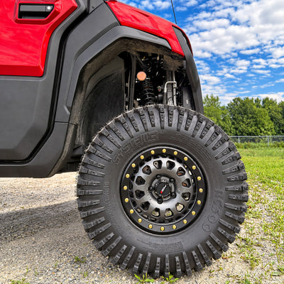 Close-up of front left 32x10.00R15NHS System3 RC500 tire on red CFMOTO UForce U10 XL Pro Highland — equipped with PERFEX 2.5in lift kit and heavy-duty bracket system.