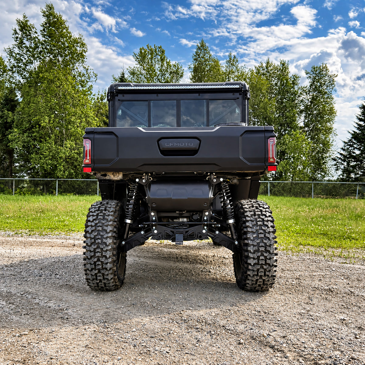 Rear view of red CFMOTO UForce U10 XL Pro Highland, lifted with PERFEX kit and riding on 32-inch System3 RC500 tires — 50-inch LED light bar visible.