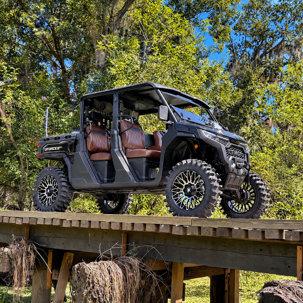 CFMOTO UForce U10 XL PRO with PERFEX 2.5in lift kit, 33-inch System3 XT400 tires and 20-inch MSA wheels — photographed on a wooden bridge in Florida.