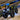 Can-Am Renegade 1000R ATV with PERFEX 2" lift kit shown from the front at dusk with headlights on and aggressive mud tires.