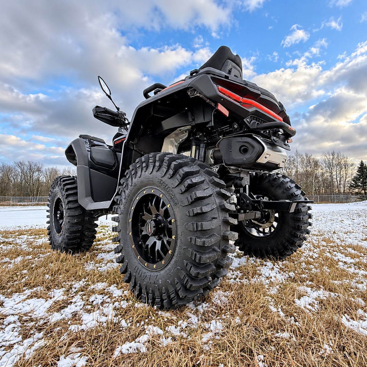 Low rear angle view of a CFMOTO CForce 1000 Touring with PERFEX 2-inch lift kit, highlighting the rear suspension and 30-inch System 3 XT400 tires.