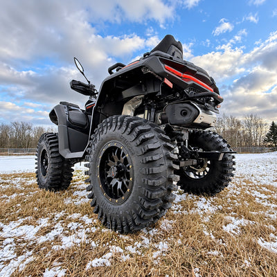 Low rear angle view of a CFMOTO CForce 1000 Touring with PERFEX 2-inch lift kit, highlighting the rear suspension and 30-inch System 3 XT400 tires.