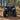 Front view of a CFMOTO CForce 1000 ATV with a PERFEX 2-inch lift kit and aggressive off-road tires in a wooded setting.