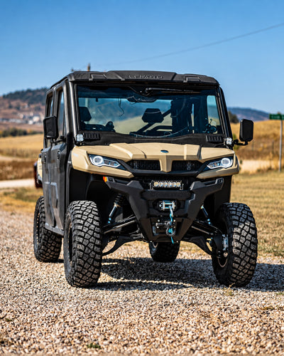 Front view of a lifted CFMOTO UForce 1000XL UTV showing its raised stance and front suspension with the PERFEX 2-inch lift kit.