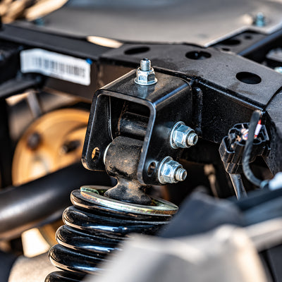 Close-up of the bolt-on PERFEX rear shock relocation adjustable bracket installed on a CFMOTO UForce 1000 UTV.