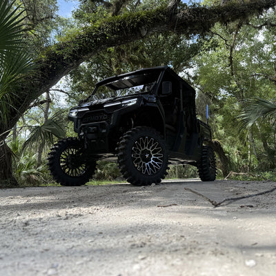 Side view of U10 lifted black on black CFMoto UForce U10 XL PRO featuring PERFEX 2.5in lift kit, 33-inch System3 XT400 tires and 20-inch MSA wheels