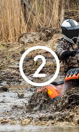 Featured on the 'Become Affiliate' page, the image depicts the number 2 in the center, representing the second step out of 4 to become an affiliate with Perfex. A person on their ATV is seen navigating through a mud hole.