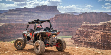 Polaris RZR 1000 XP atop a mountain for the 'Contact Us' page of the Perfex website.