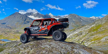 Honda Talon 1000 X-4 UTV on a rock amidst the mountains for the 'Customer Reviews' page of the Perfex website.