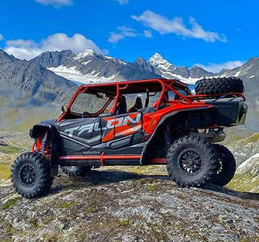 Honda Talon 1000 X-4 UTV on a rock amidst the mountains for the 'Customer Reviews' page of the Perfex website.