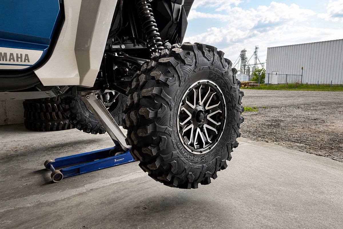 Reinstalling an ATV or UTV wheel onto the wheel spacer studs and hand-tightening the wheel lug nuts before final torque.