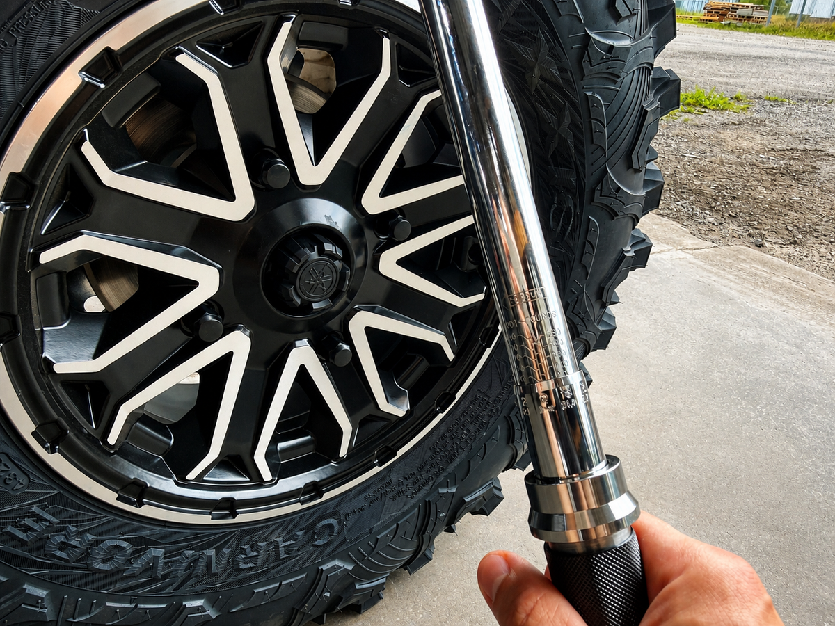 Final torquing of ATV or UTV wheel lug nuts in a star pattern using a torque wrench after wheel spacer installation.