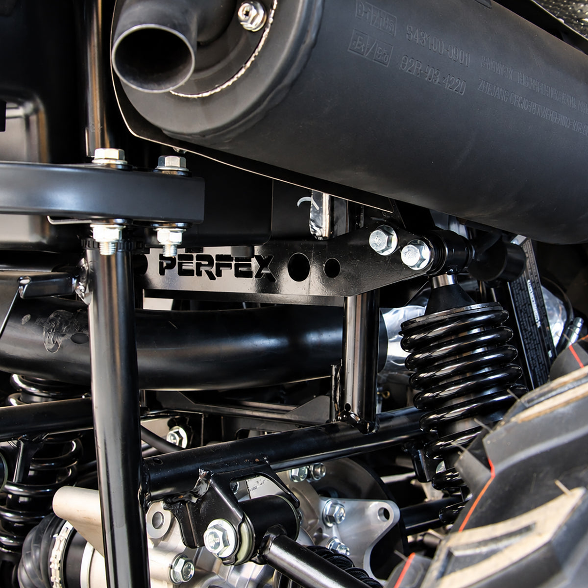 Detailed view of the PERFEX rear suspension lift brackets mounted above the shock on a CFMOTO CForce 400 ATV.