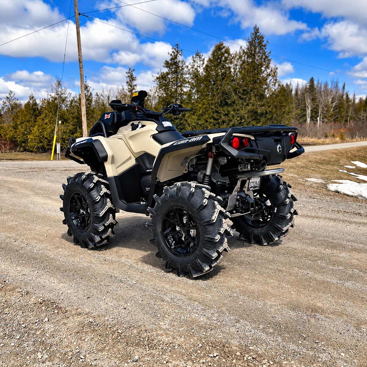 Rear three-quarter view of a Can-Am Outlander X MR 850 equipped with a PERFEX 2" lift kit and mud tires.