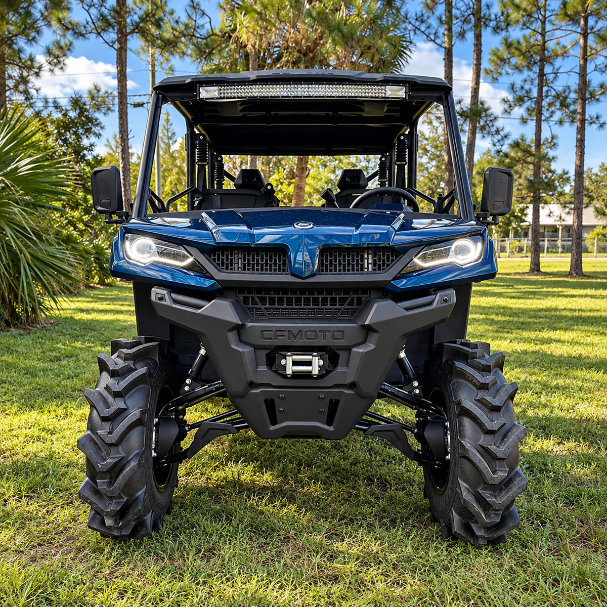 Front view of a blue CFMOTO UForce 1000 XL equipped with a PERFEX 2-inch suspension lift and aggressive 32" mud tires.